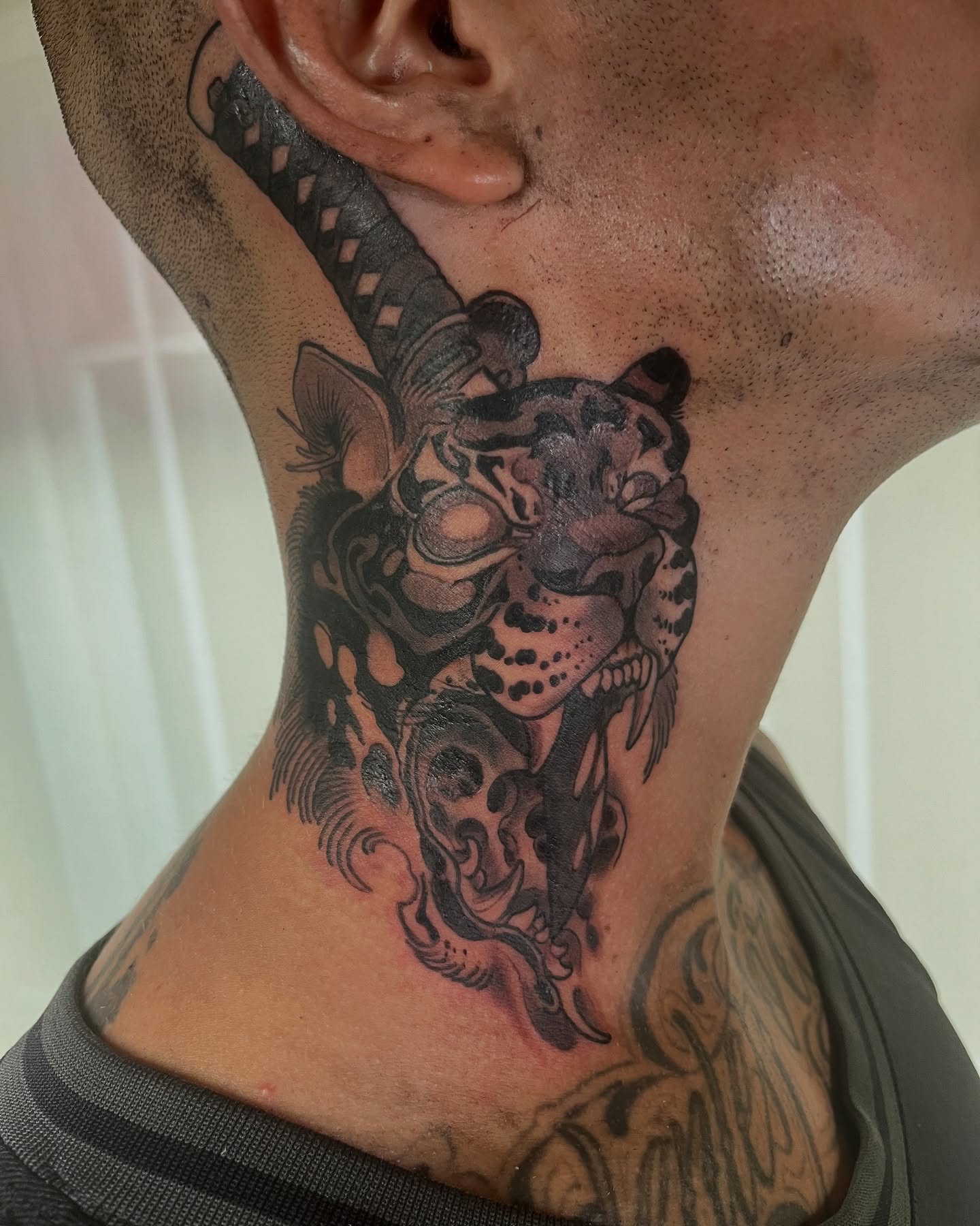 Leopard and skull neck tattoo black and grey
